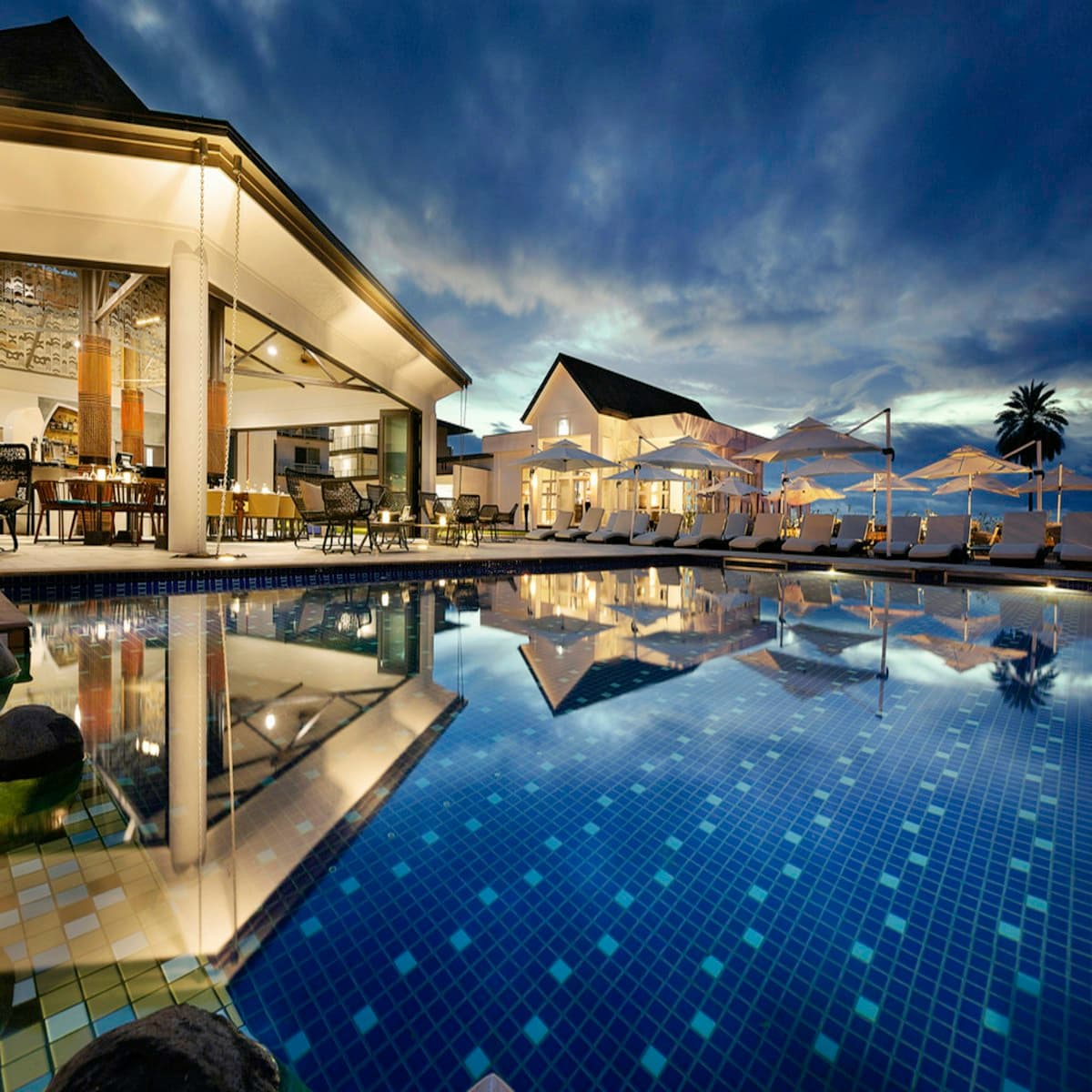 Resort pool and lounge area at dusk